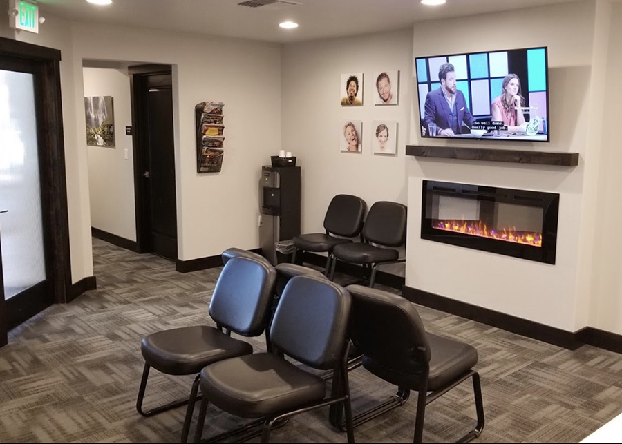 The waiting area is warmed by a fireplace, a tv plays a movies